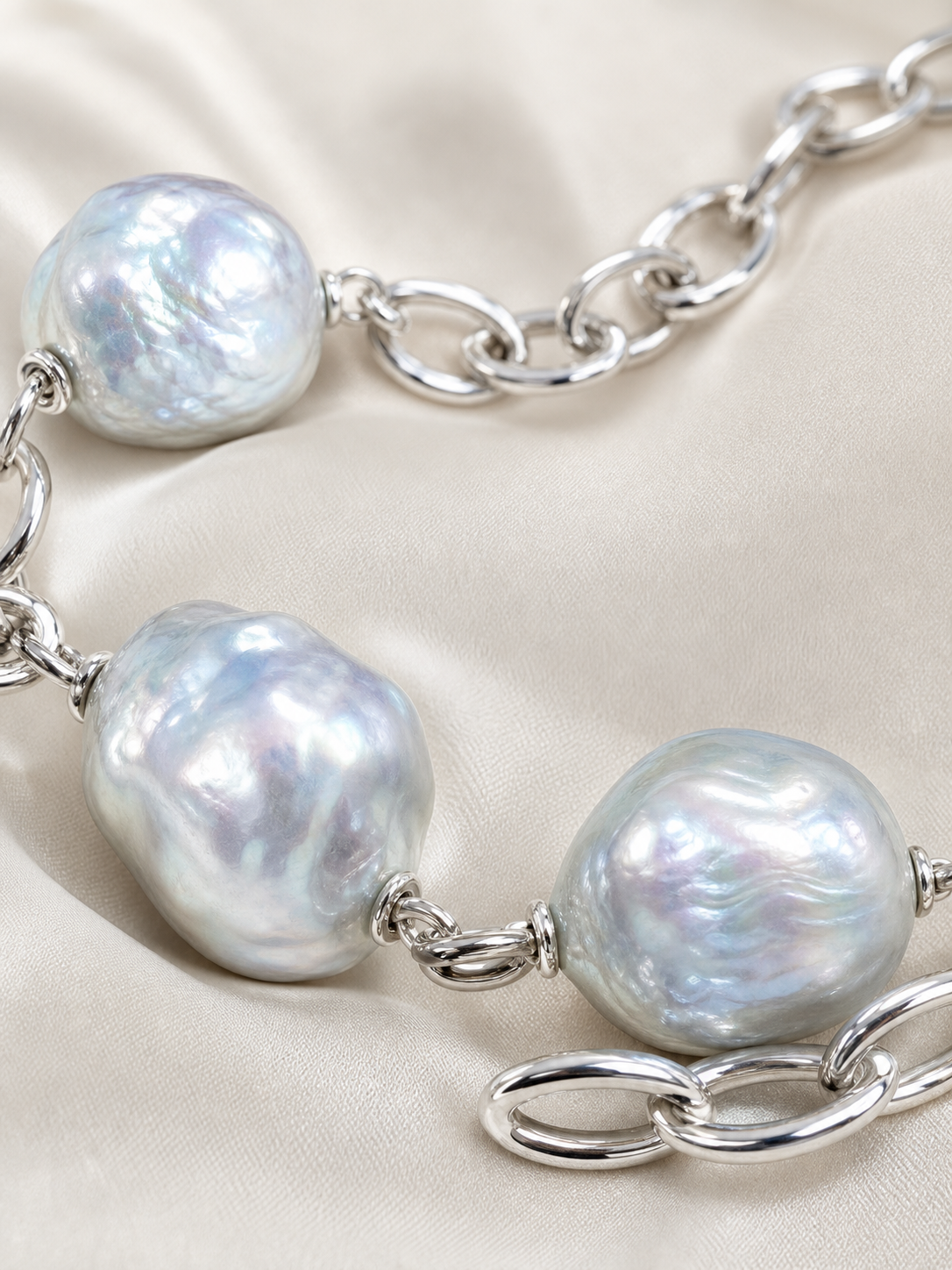 Close-up of Blue Aurora necklace baroque pearl surface showing mirror-like gloss and blue-gray aurora overtone