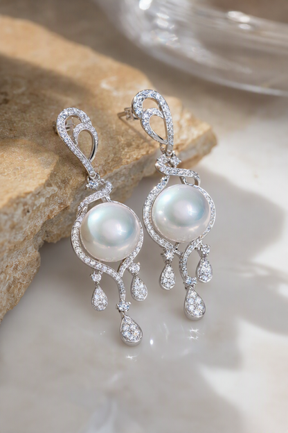 Halo and tassel detail around 11–12mm Australian South Sea pearls on S925 sterling silver stud earrings, close detail