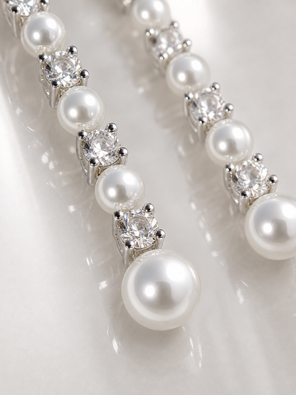 Detail of White Freshwater Pearl Meteor Earrings showing round to near round pearls, mirror-like surface quality and S925 silver fittings