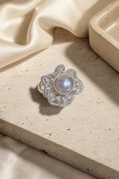 11–12mm White South Sea Pearl Floral Halo Sterling Silver Ring in a still-life ivory silk luxury environment