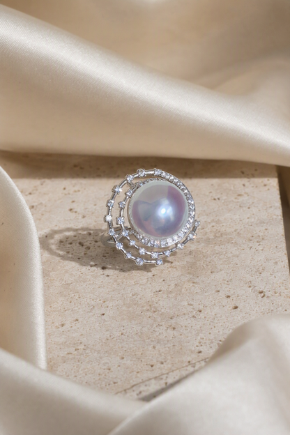11–12mm White South Sea Pearl Open Halo Sterling Silver Ring in a still-life ivory silk luxury environment