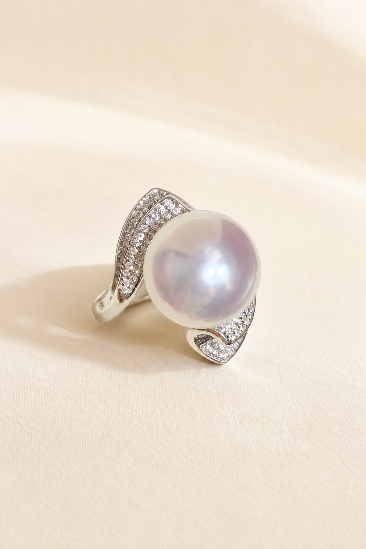 11–12mm White South Sea Pearl Sculptural Wave Sterling Silver Ring on a cream white primary background