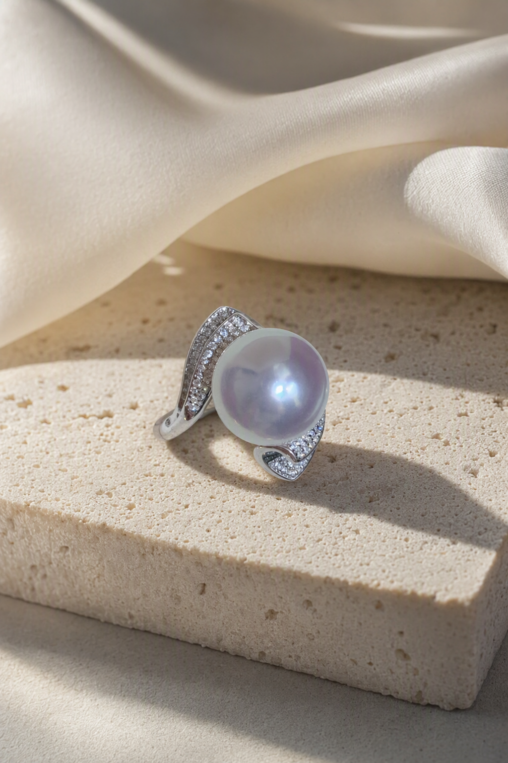 11–12mm White South Sea Pearl Sculptural Wave Sterling Silver Ring in a still-life ivory silk luxury environment