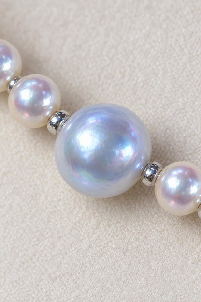 Close-up of High Luster Small pearls 3.5–4 mm; large blue-gray pearls 8.5–9 mm Cultured Freshwater Pearl necklace showing pearl luster, nacre and craftsmanship detail