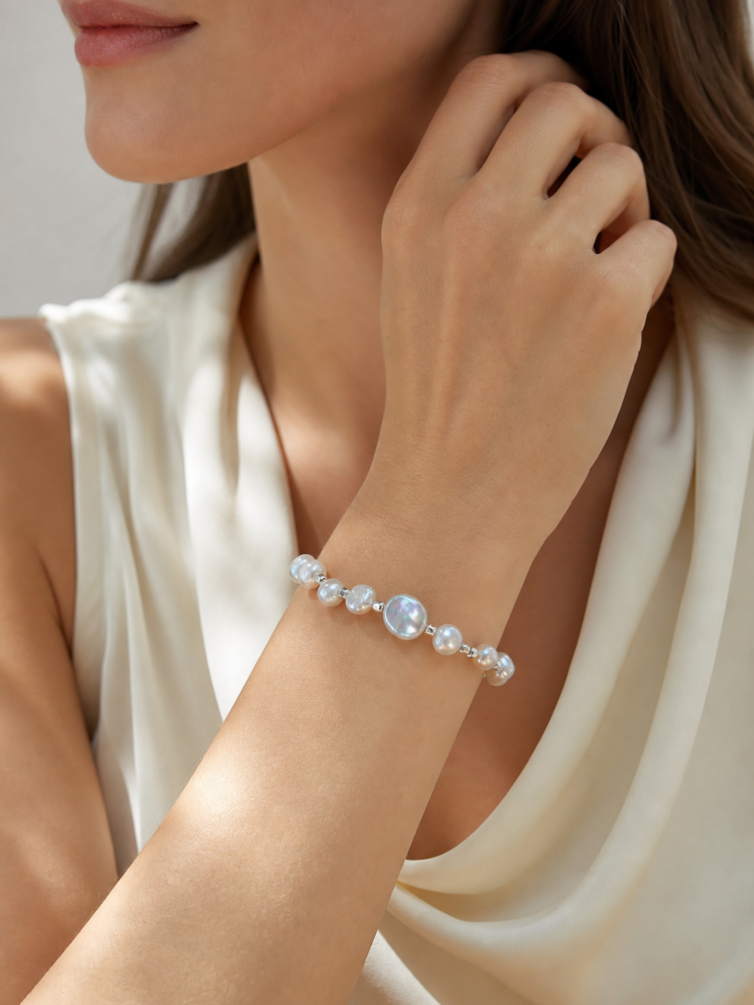 Model wearing aurora freshwater baroque pearl bracelet with cool silver-blue mirror-like luster