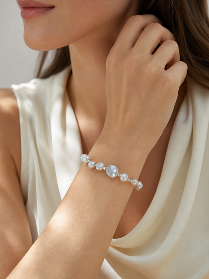 Model wearing aurora freshwater baroque pearl bracelet with cool silver-blue mirror-like luster