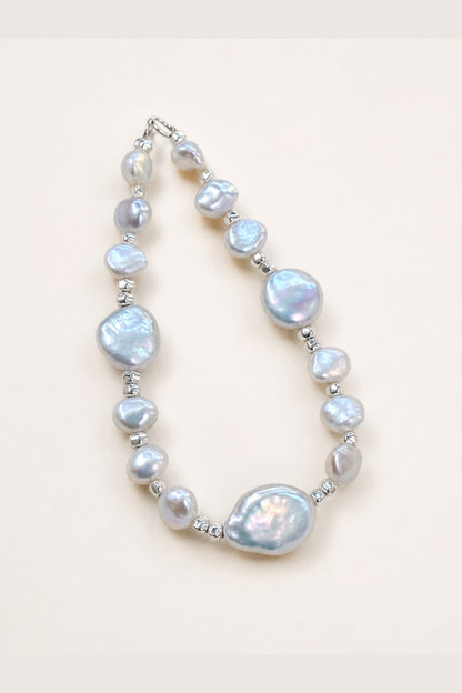 Aurora freshwater pearl bracelet with silver-blue color and mirror-like luster on a clean background
