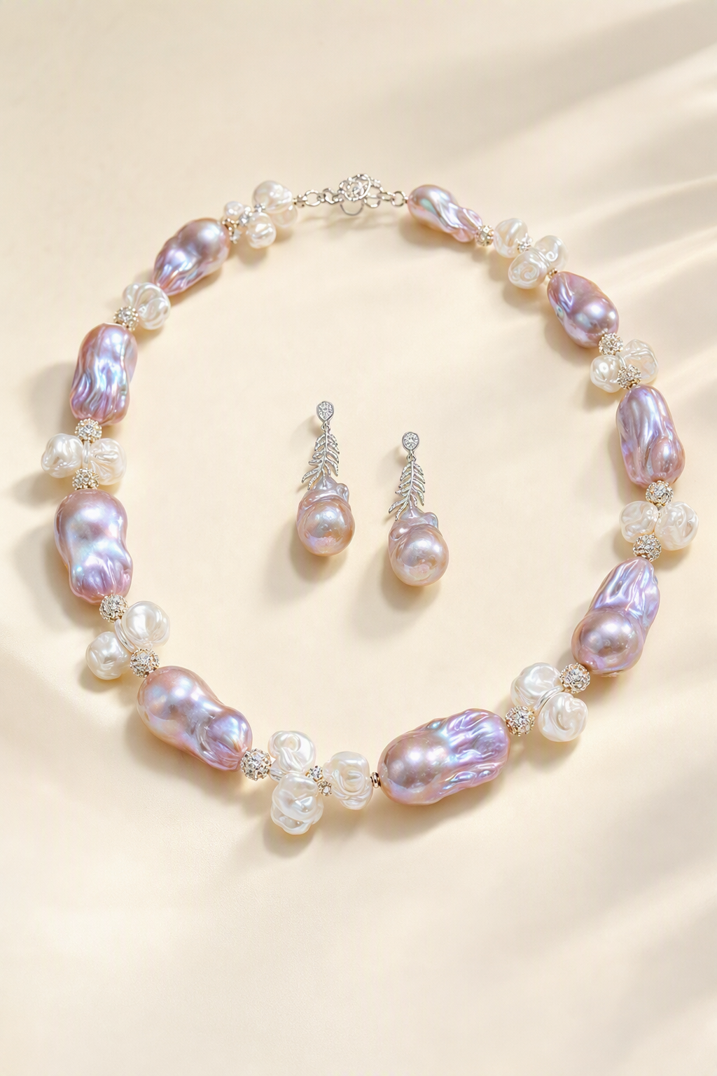 Aurora Luster 20mm+ Freshwater Pearl necklace and earrings set on a cream white background