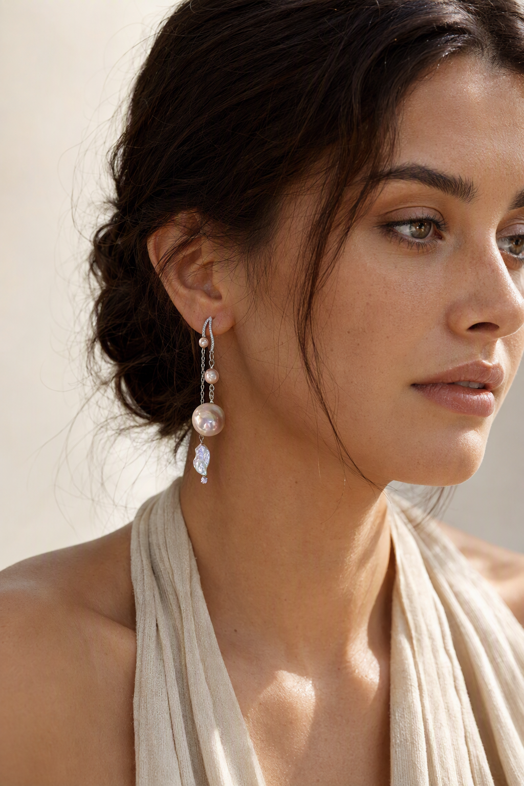 Model wearing High Luster Freshwater Pearl dangle earrings naturally on the earlobe