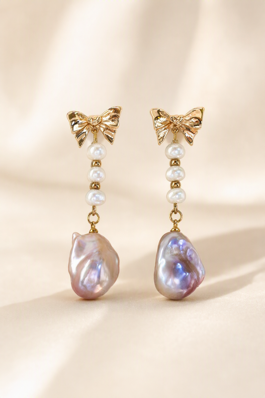 High Luster Freshwater Pearl drop earrings on a cream white background