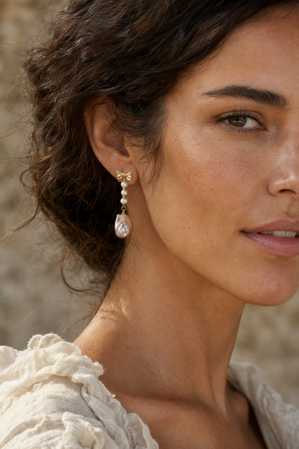 Model wearing High Luster Freshwater Pearl drop earrings naturally on the earlobe