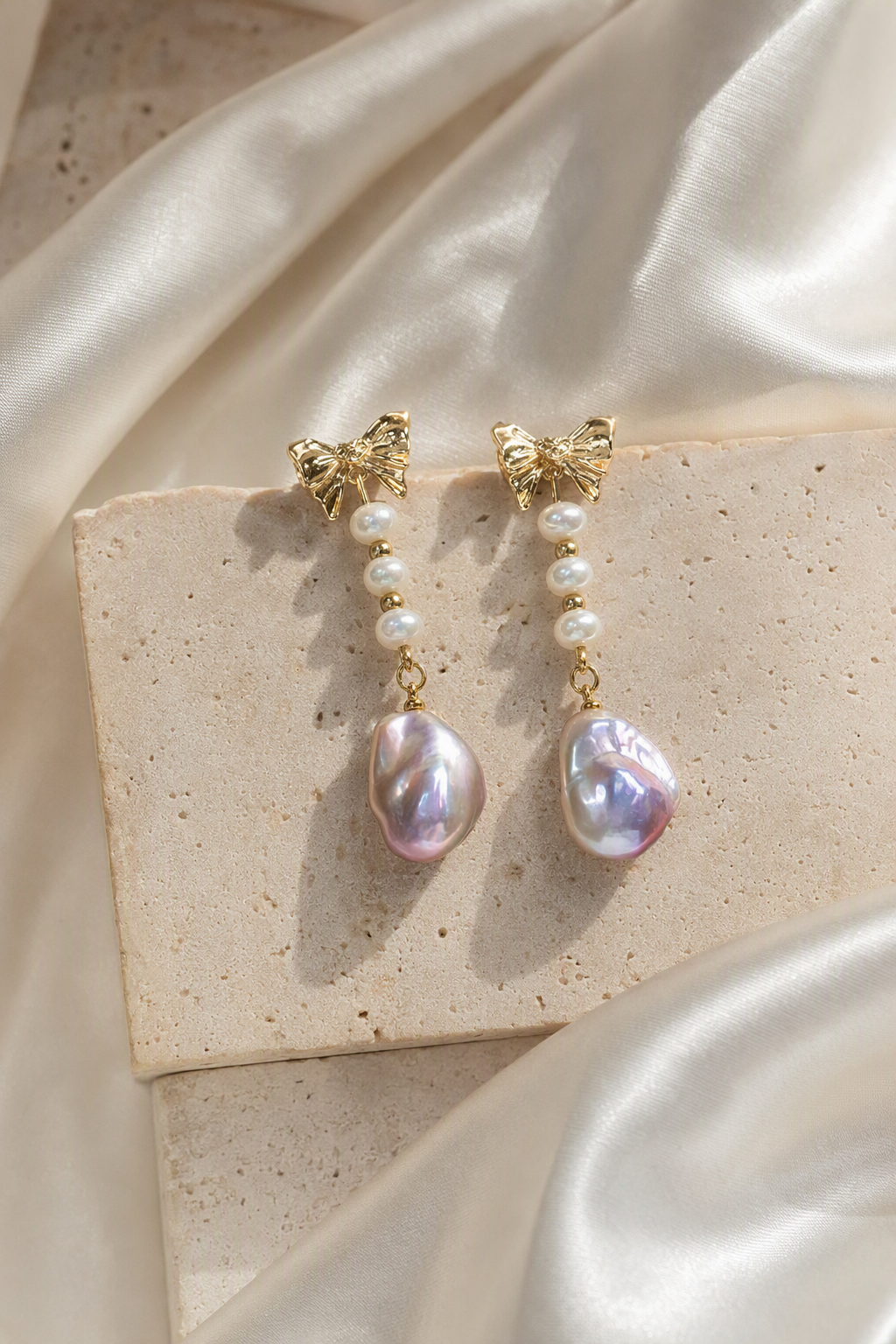 High Luster Freshwater Pearl drop earrings in an elegant still-life luxury setting