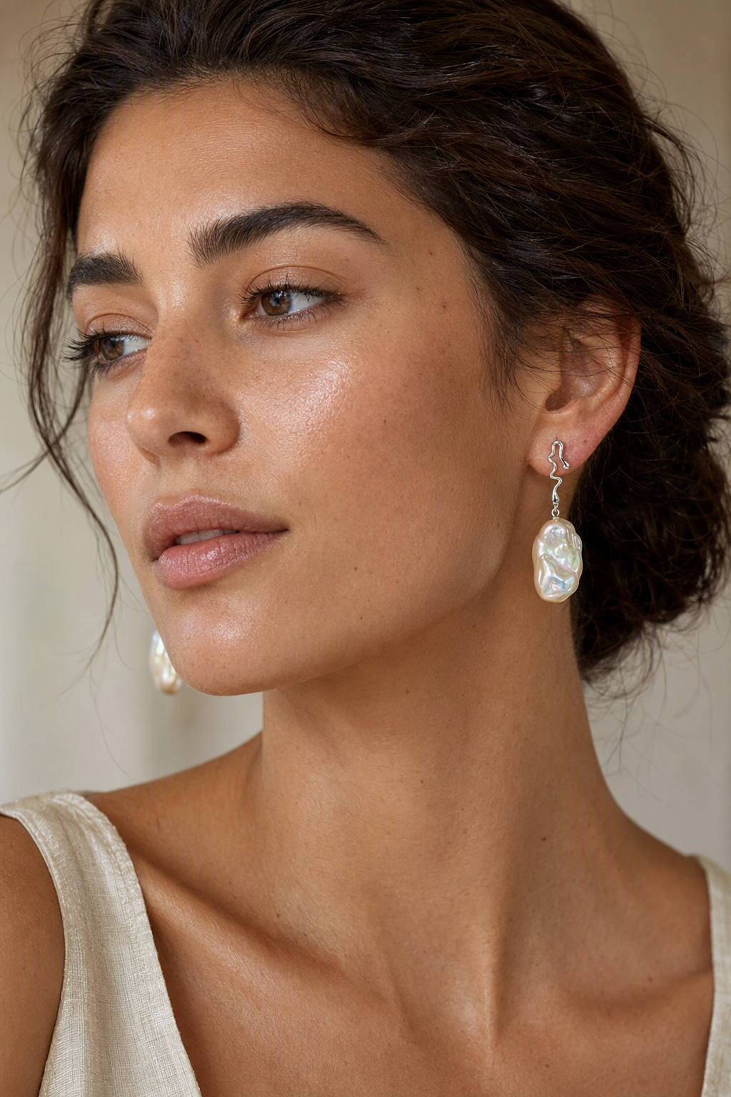 Model wearing High Luster Freshwater Pearl drop earrings naturally on the earlobe