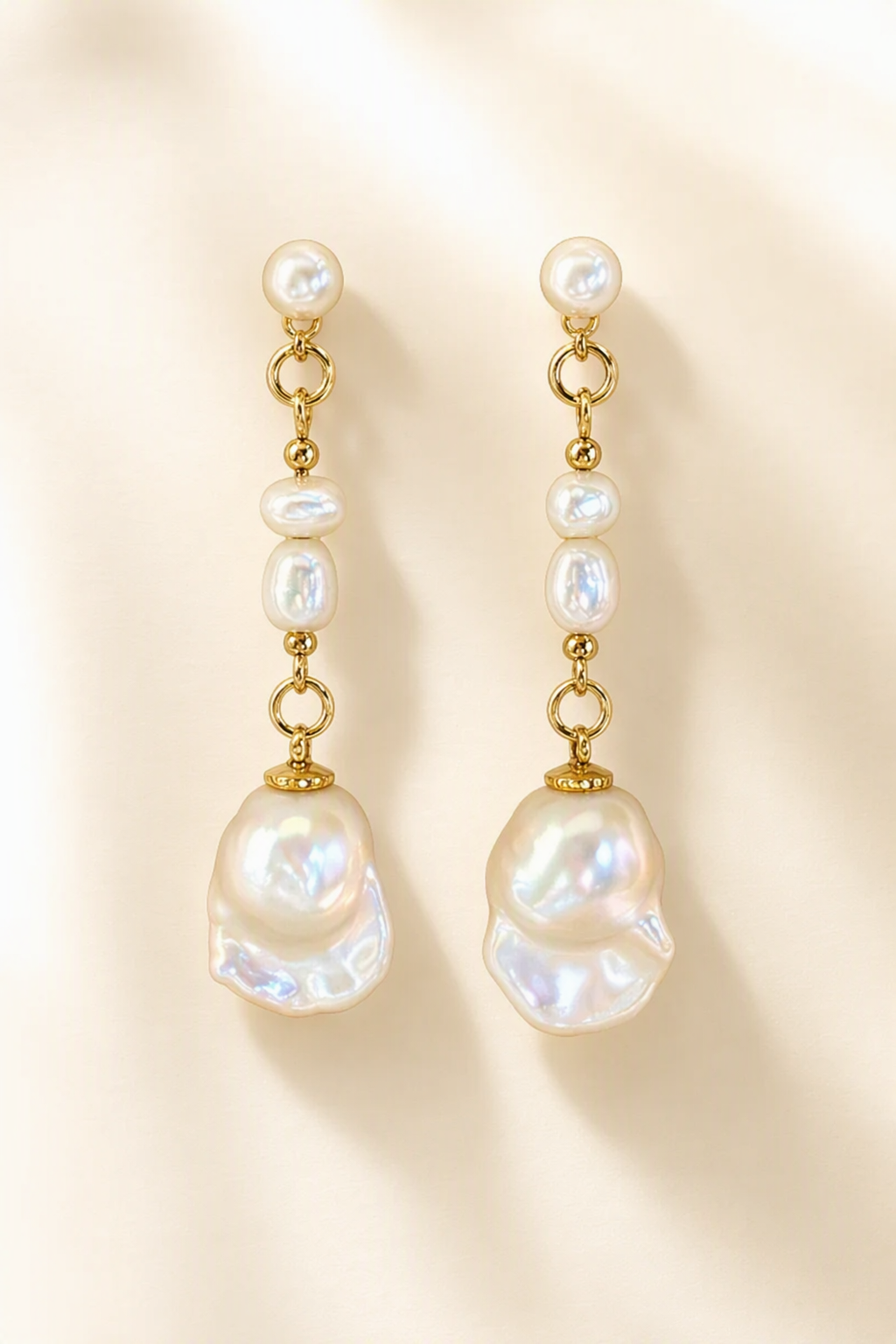 High Luster Freshwater Pearl dangle earrings on a cream white background