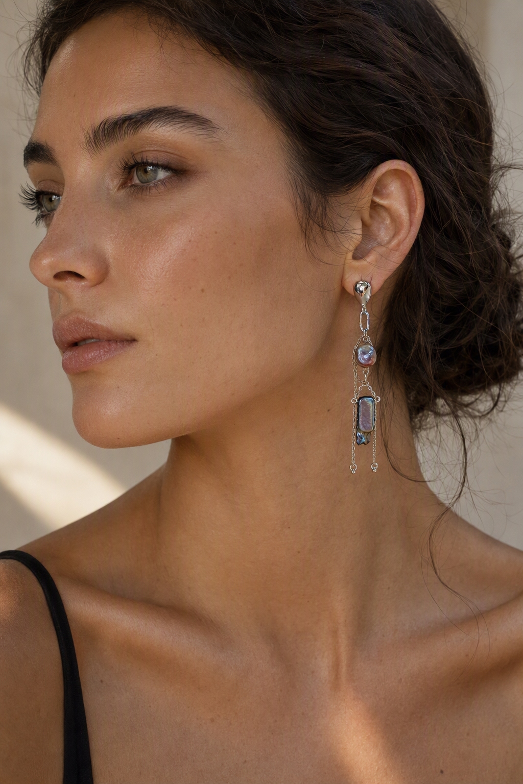 Model wearing High Luster Freshwater Pearl dangle earrings naturally on the earlobe