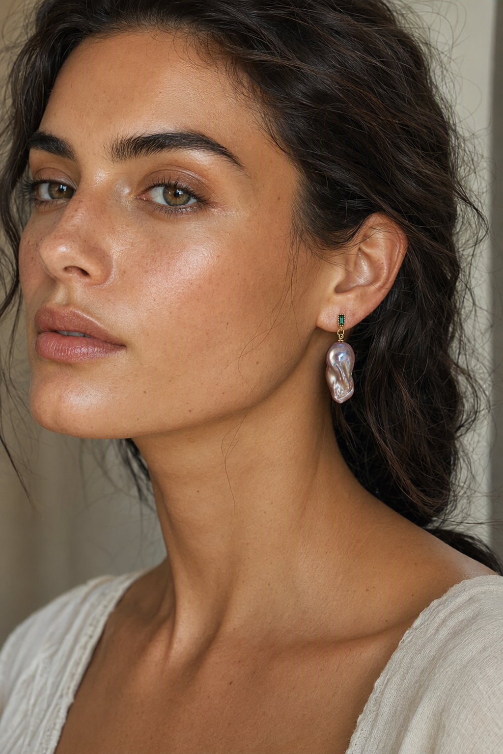 Model wearing High Luster Freshwater Pearl drop earrings naturally on the earlobe