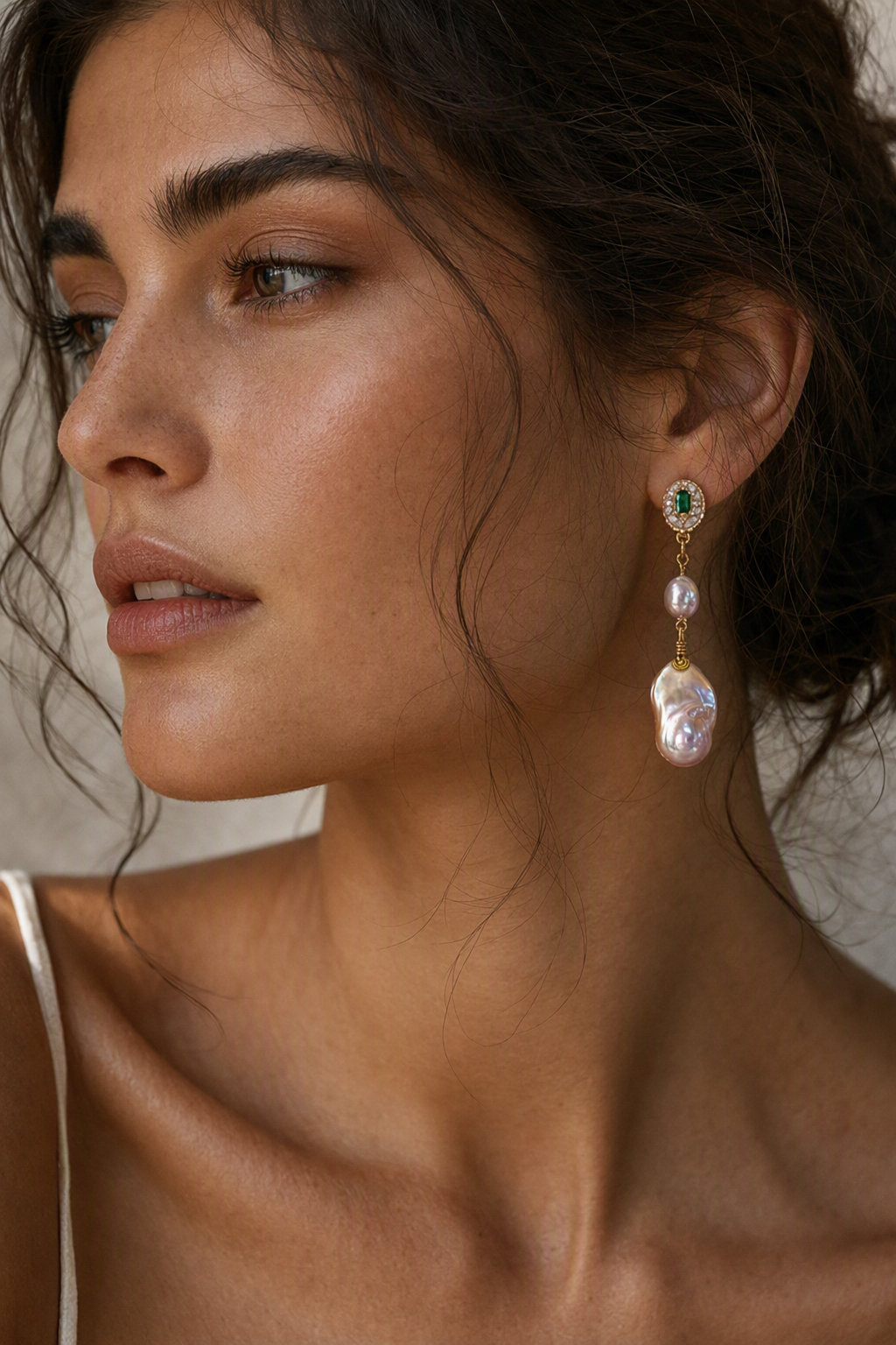 Model wearing High Luster Freshwater Pearl drop earrings naturally on the earlobe