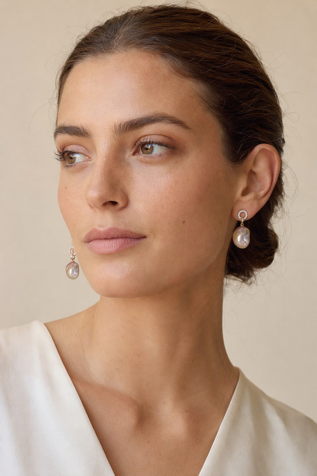 Model wearing High Luster Freshwater Pearl drop earrings naturally on the earlobe