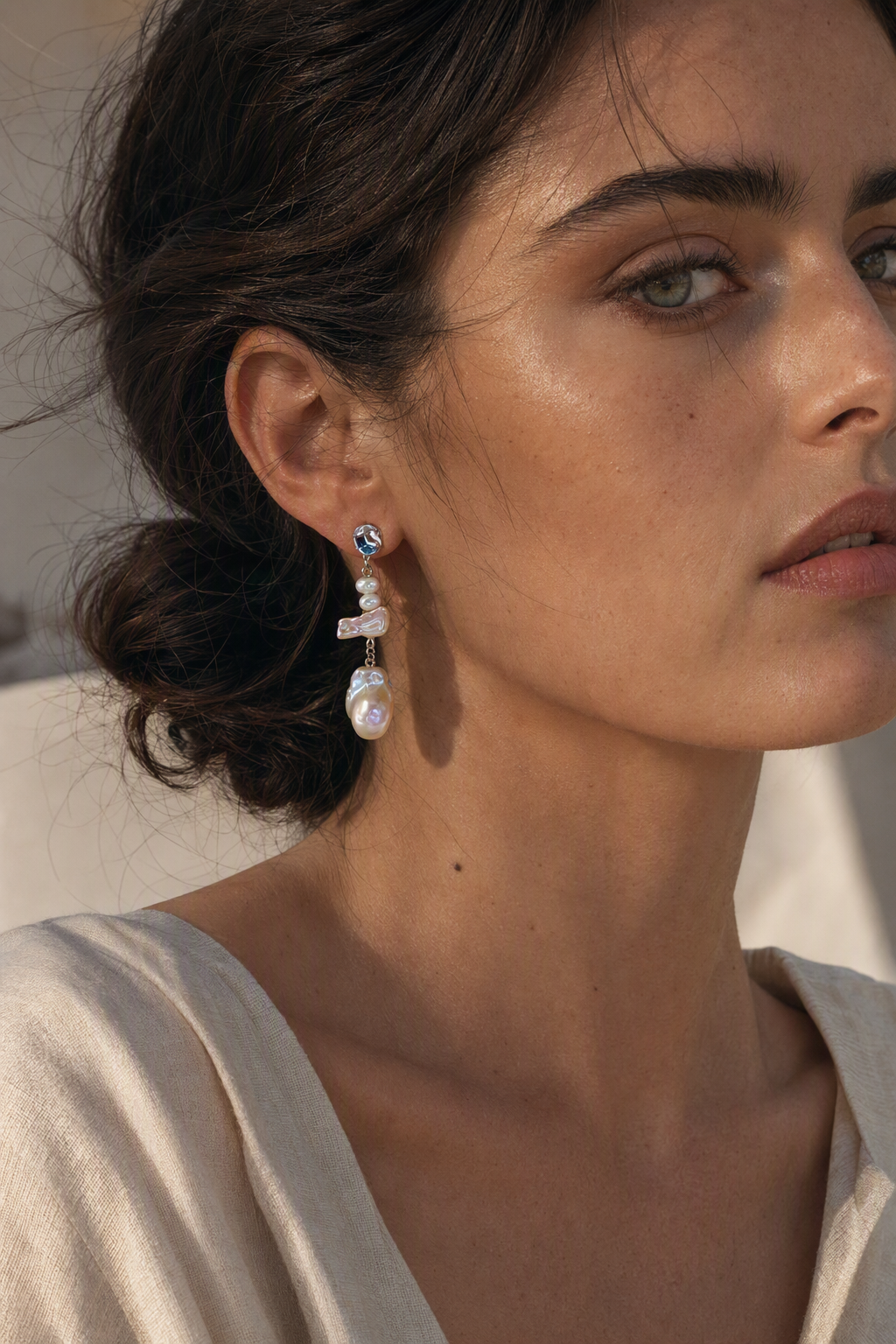 Model wearing High Luster Freshwater Pearl dangle earrings naturally on the earlobe