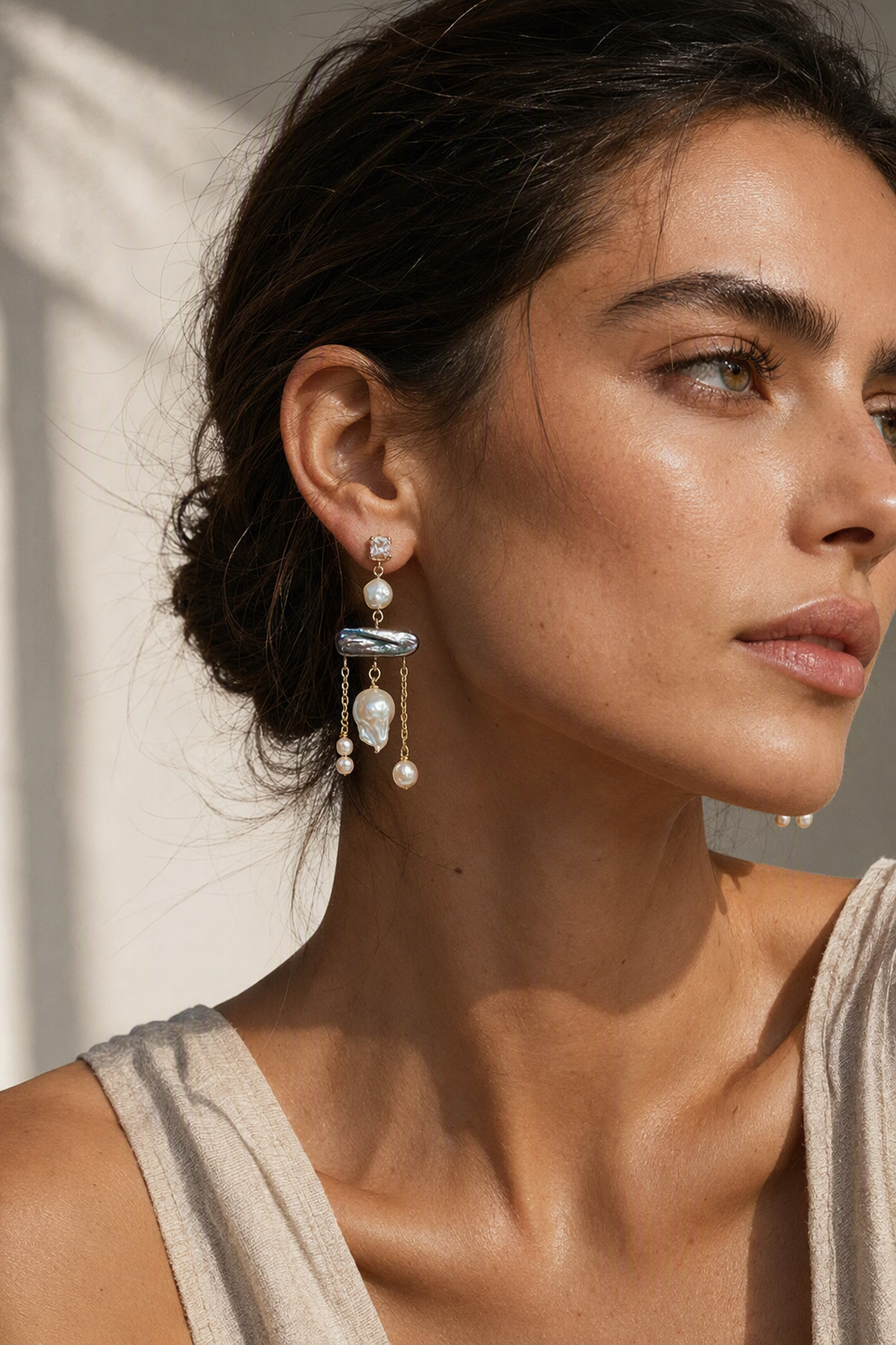 Model wearing High Luster Freshwater Pearl dangle earrings naturally on the earlobe