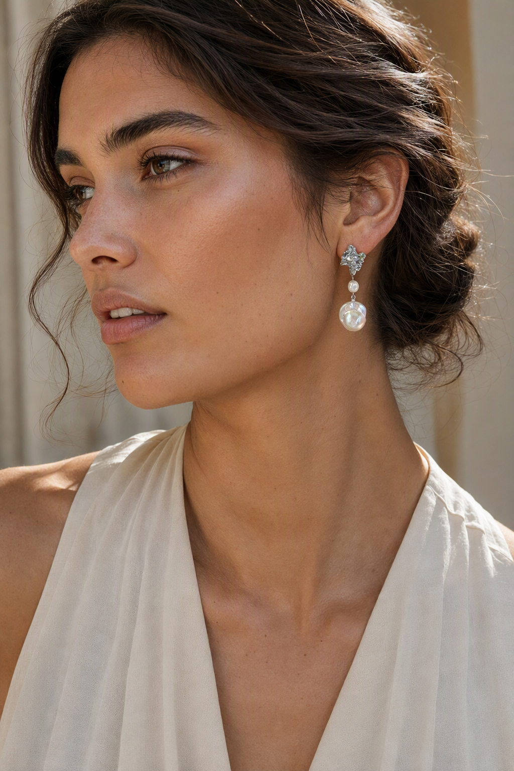 Model wearing High Luster Freshwater Pearl drop earrings naturally on the earlobe