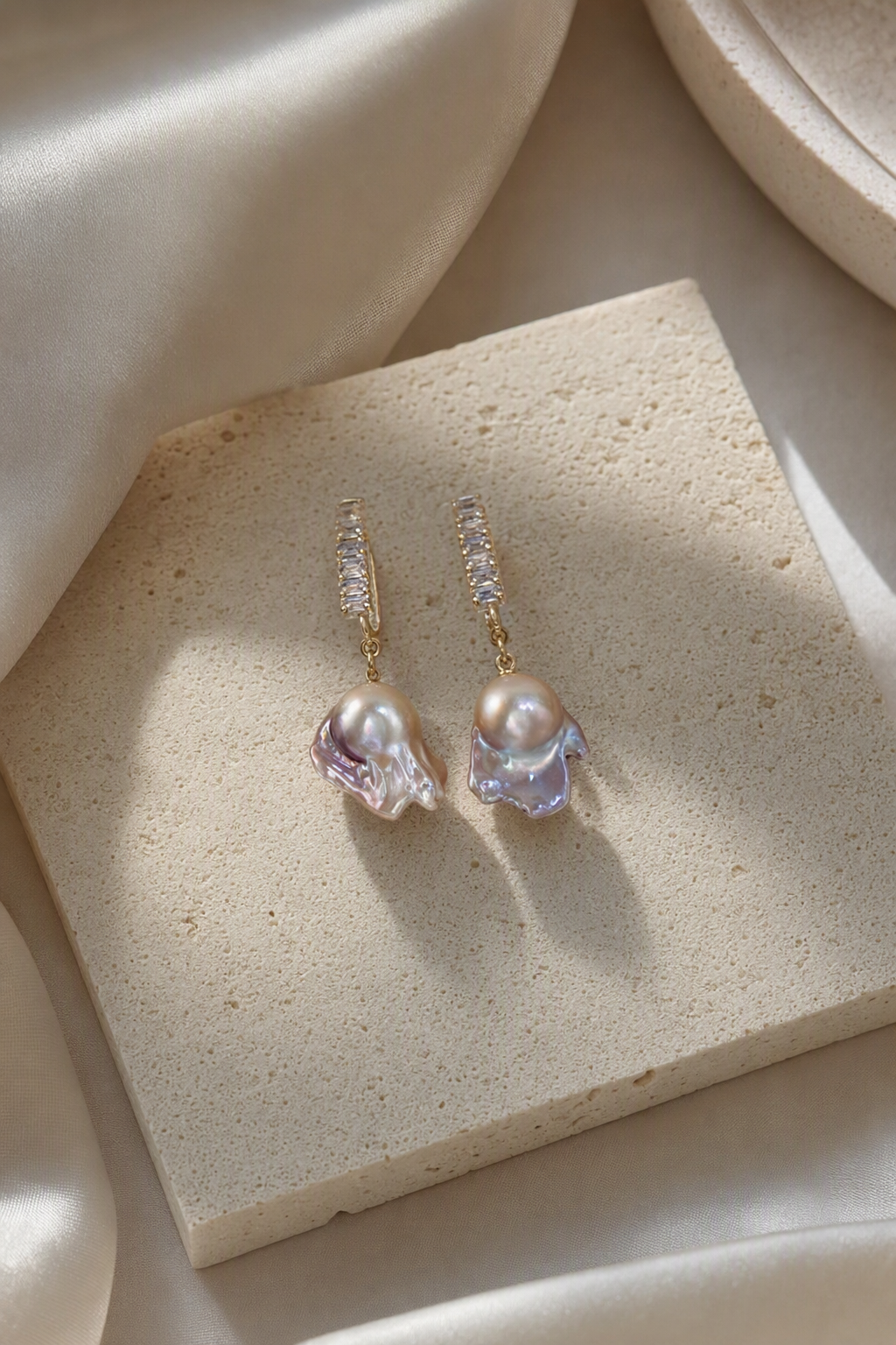High Luster Freshwater Pearl drop earrings in an elegant still-life luxury setting