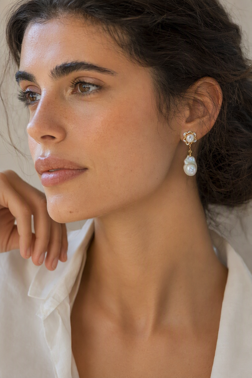 Model wearing High Luster Freshwater Pearl drop earrings naturally on the earlobe