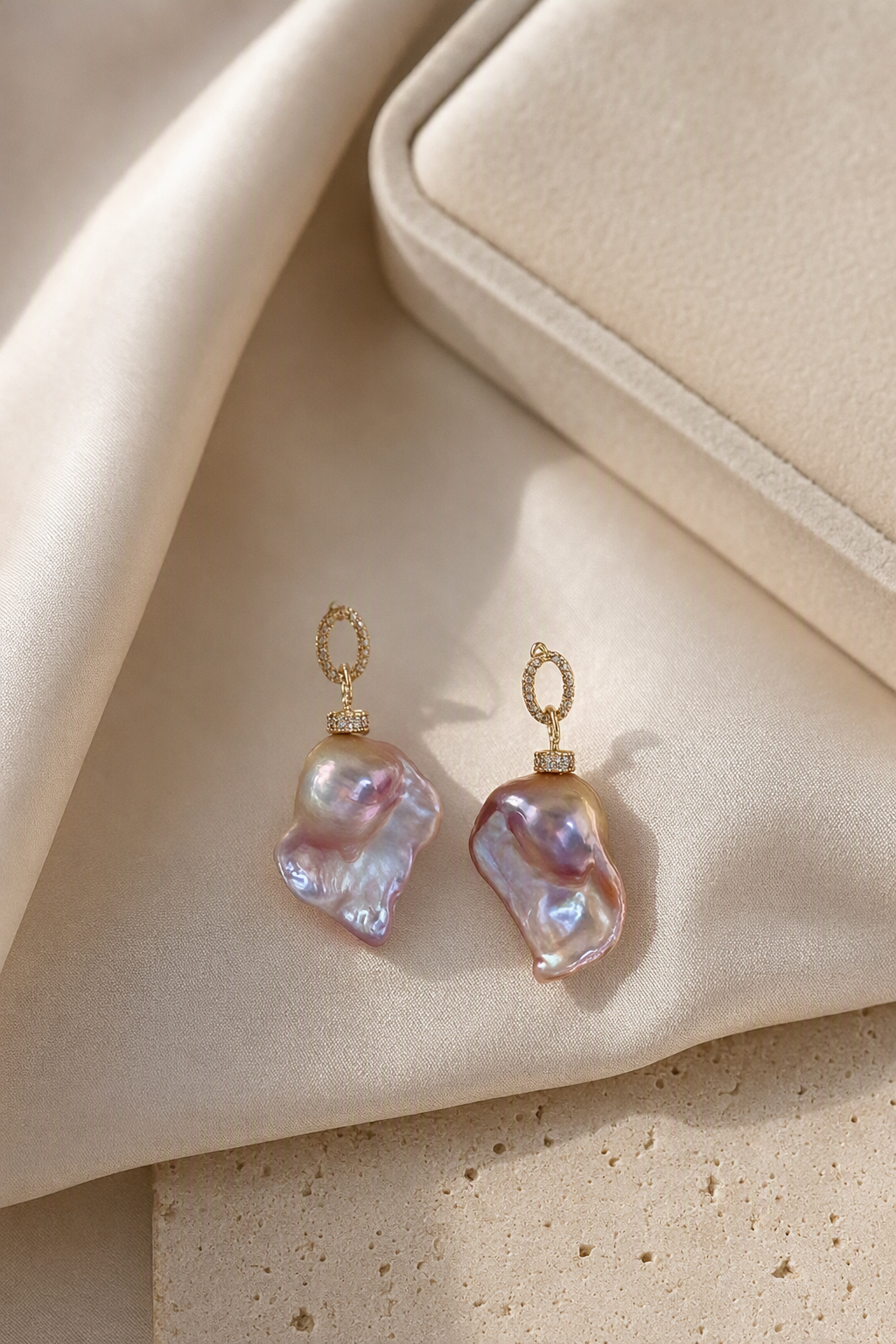 High Luster Freshwater Pearl drop earrings in an elegant still-life luxury setting