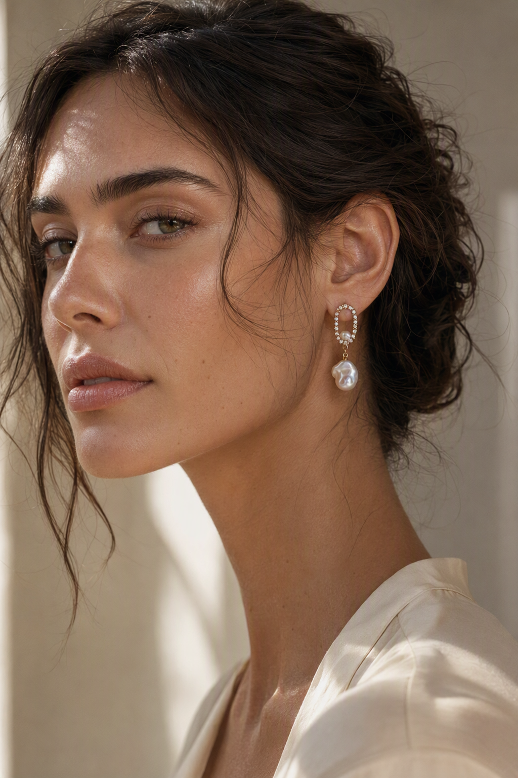 Model wearing High Luster Freshwater Pearl drop earrings naturally on the earlobe
