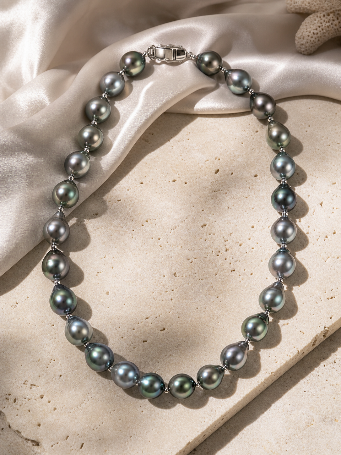 Tahitian pearl necklace featuring gray black pearls with mirror-like blue green luster