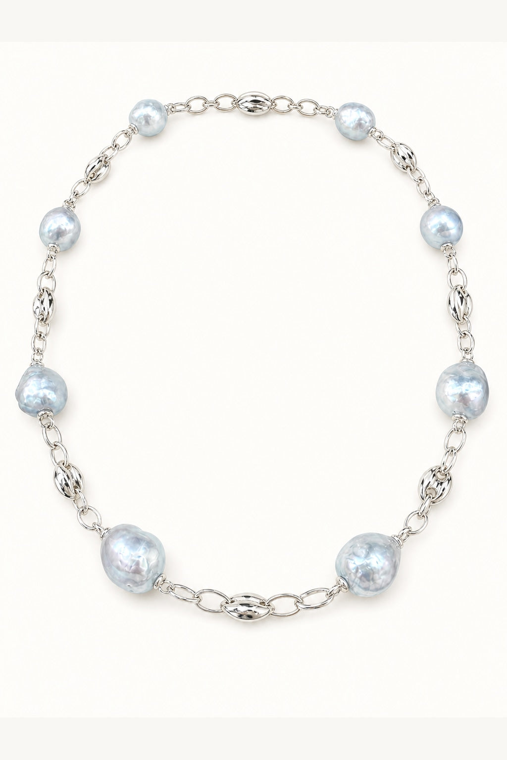 Blue freshwater pearl necklace with mirror-like luster and large baroque pearls on cream white background