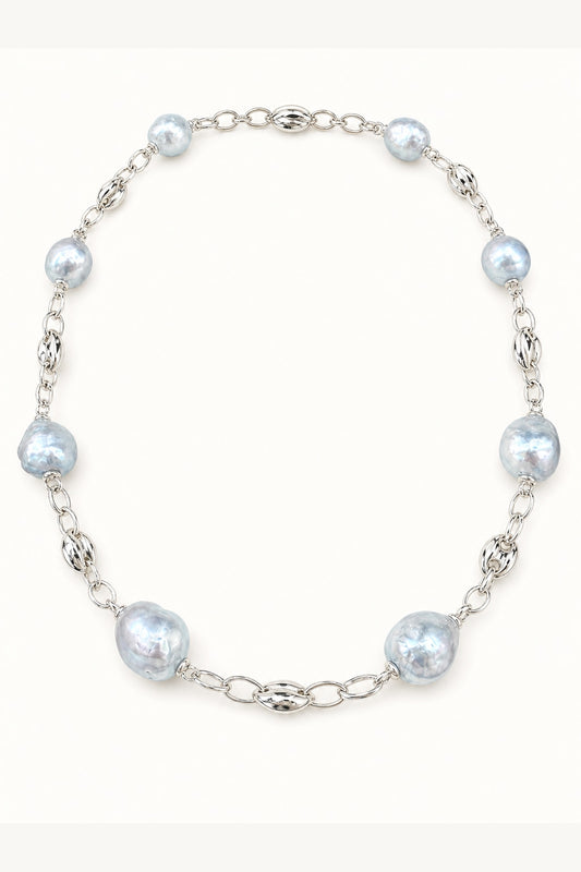 Blue freshwater pearl necklace with mirror-like luster and large baroque pearls on cream white background