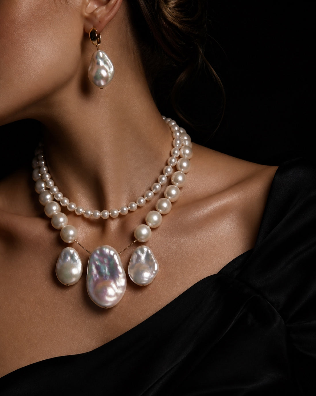 Layered iridescent baroque pearl jewelry editorial portrait