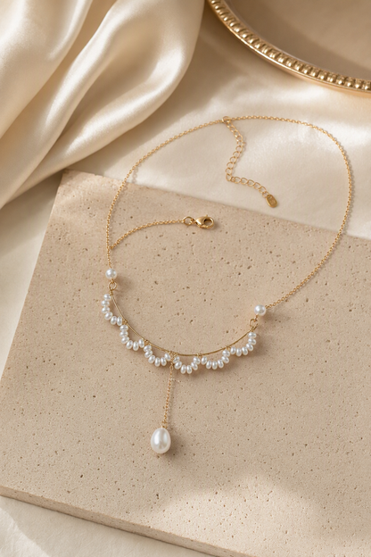 Mirror Luster 2–3 mm fringe pearls; 4–5 mm side pearls; 6–9 mm teardrop focal pearl Freshwater Pearl necklace in an elegant still-life luxury setting