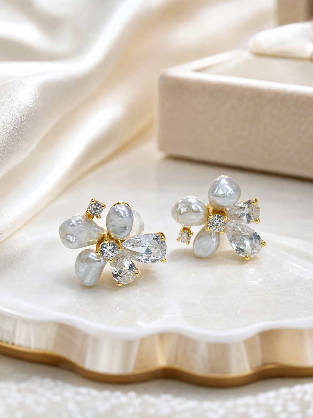 real pearl jewelry styled on silk with gold-tone freshwater pearl stud earrings