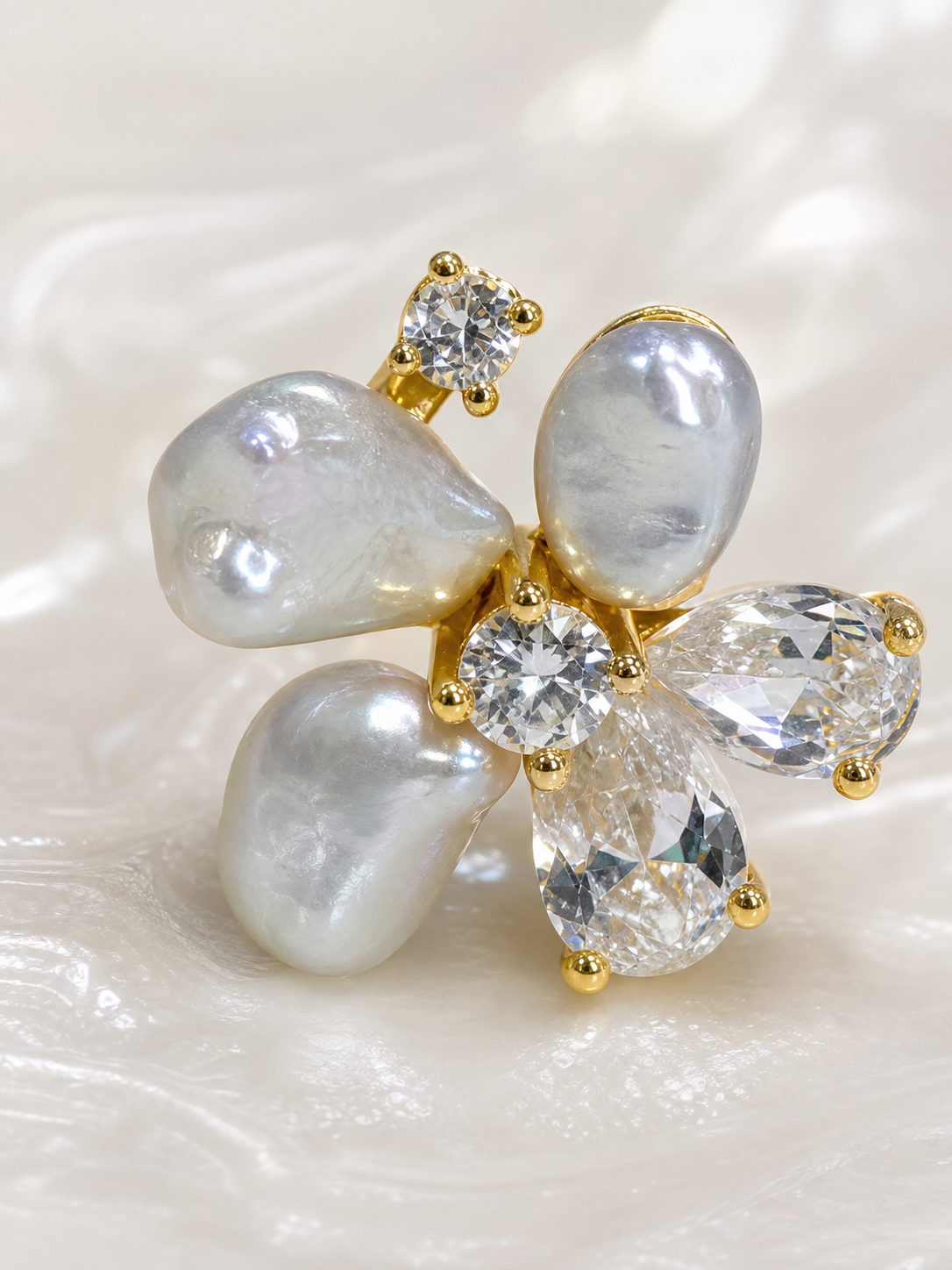 Macro detail of one freshwater keshi pearl earring with high nacre luster