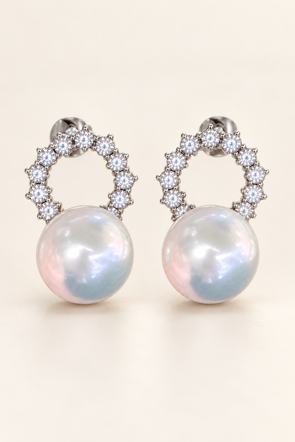 Gem Luster 11–13 mm Australian South Sea Pearl stud earrings on a cream white background