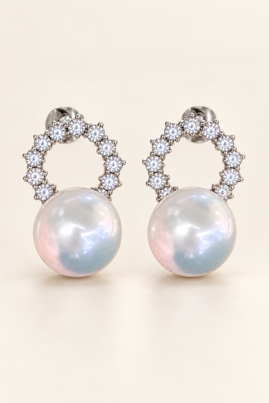 Gem Luster 11–13 mm Australian South Sea Pearl stud earrings on a cream white background