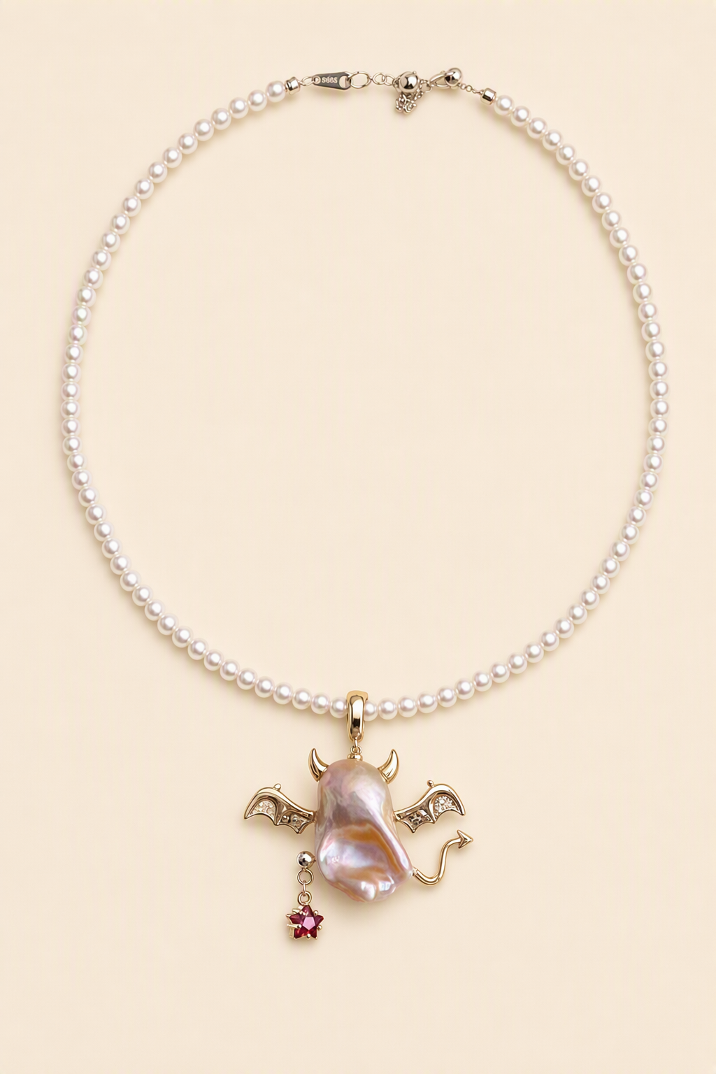 Winged Devil Star Drop baroque pearl pendant with a white small pearl necklace by Pearlivo