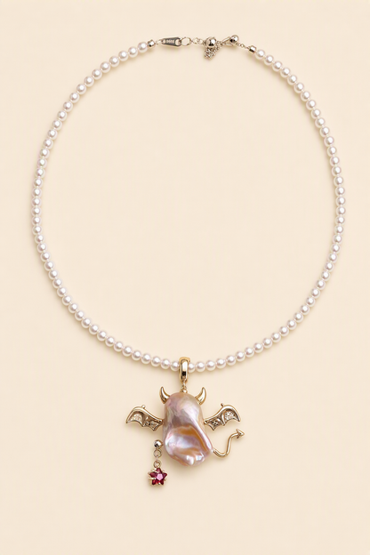 Winged Devil Star Drop baroque pearl pendant with a white small pearl necklace by Pearlivo