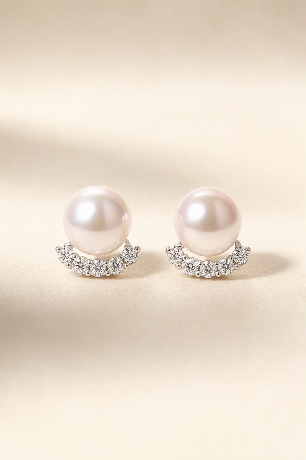 Mirror Luster 10–13 mm Freshwater Pearl stud earrings on a cream white background