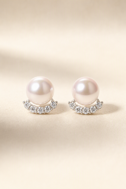Mirror Luster 10–13 mm Freshwater Pearl stud earrings on a cream white background