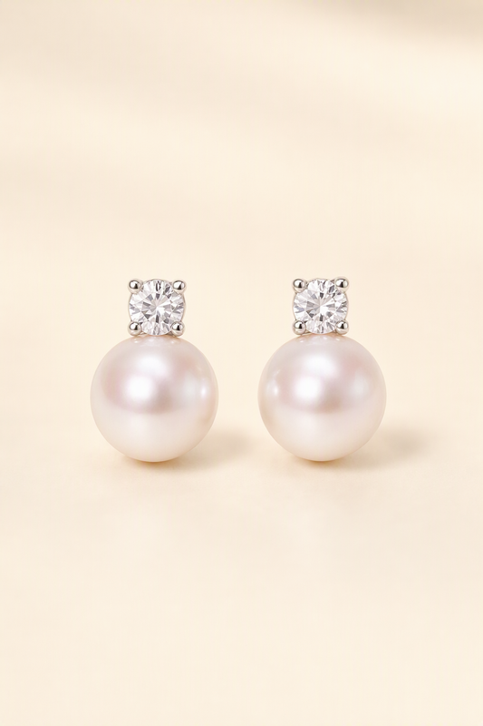 Mirror Luster 10–13 mm Freshwater Pearl stud earrings on a cream white background