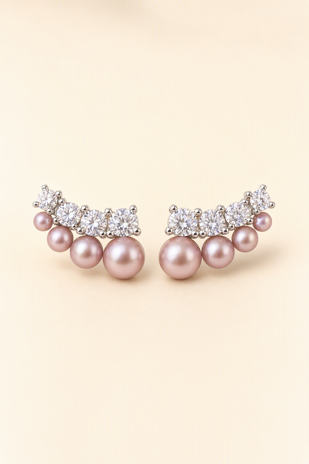 Mirror Luster 3–8 mm Graduated Freshwater Pearl stud earrings on a cream white background