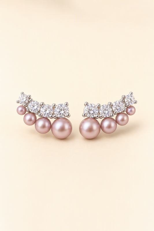 Mirror Luster 3–8 mm Graduated Freshwater Pearl stud earrings on a cream white background
