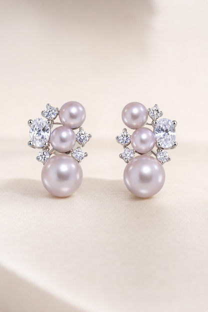 Mirror Luster 4–10 mm Graduated Freshwater Pearl stud earrings on a cream white background
