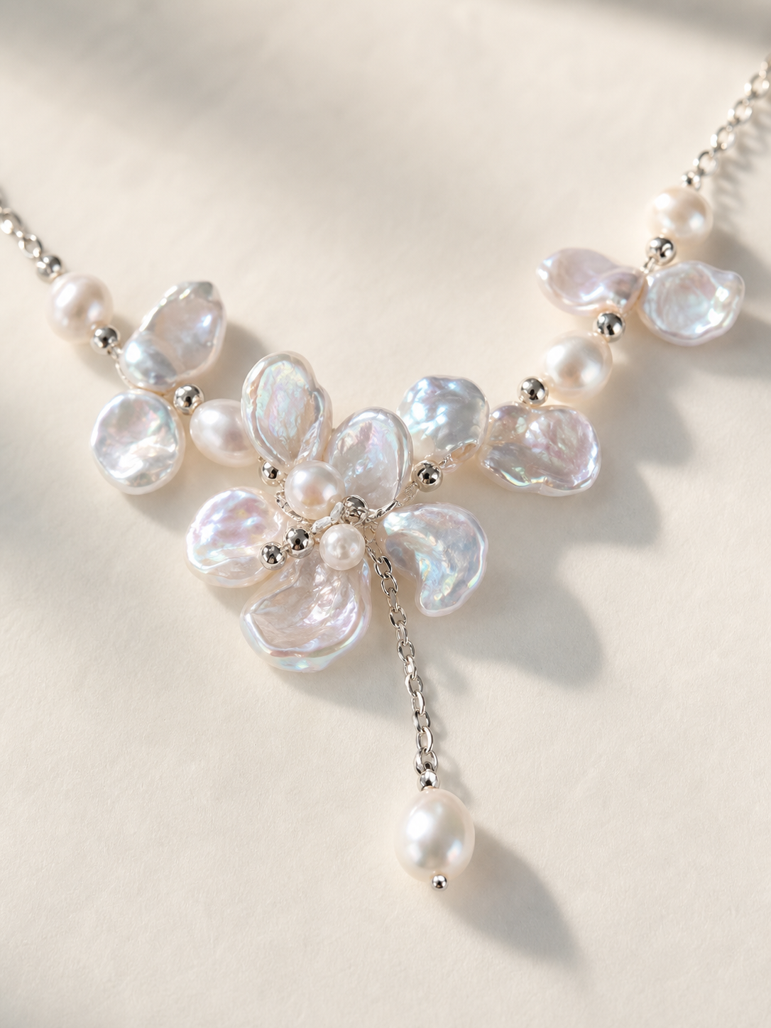 Freshwater pearl necklace featuring white baroque pearls with mirror luster and aurora overtone