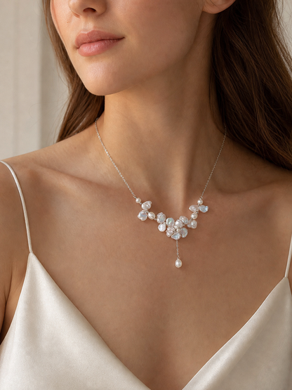 White freshwater baroque pearl necklace worn at the collarbone with mirror-like luster