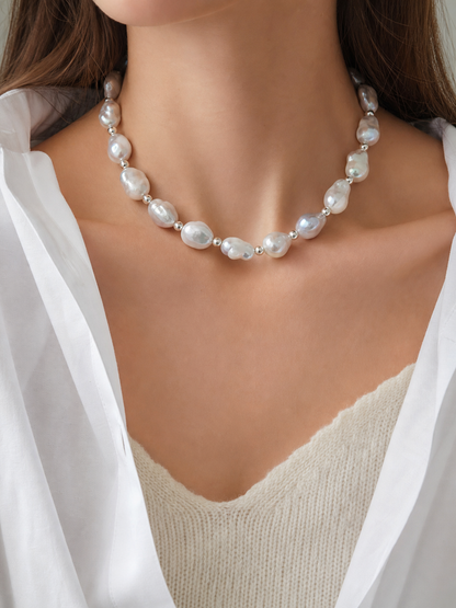 Model wearing white freshwater baroque pearl necklace with mirror-like luster in short style