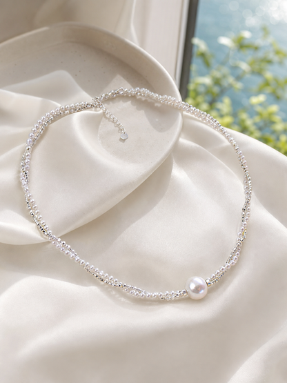 Freshwater pearl necklace featuring white small pearls and a mirror luster focal pearl